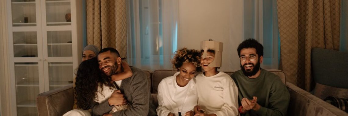 A joyful family enjoying quality time together on a comfortable sofa in a well-lit living room.